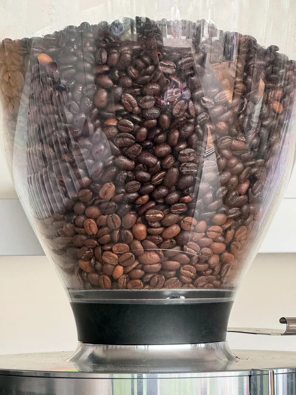 Makroaufnahme von Kaffeebohnen im Mühlentrichter